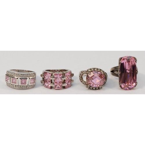 49 - Four silver and pink stone dress rings, sizes N - R, 43gm