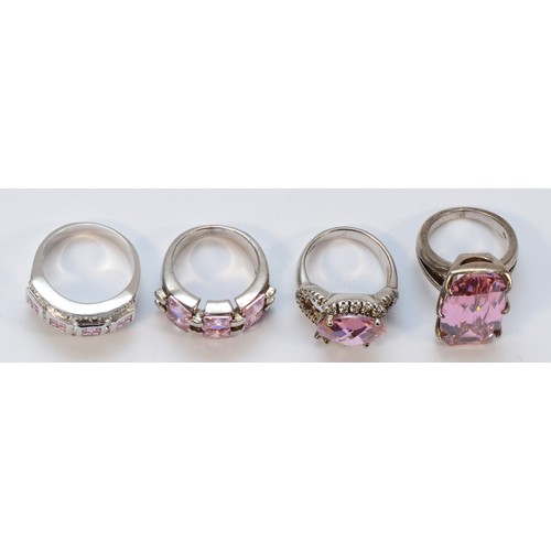 49 - Four silver and pink stone dress rings, sizes N - R, 43gm