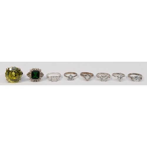 50 - A silver and yellow stone ring, 23mm, and seven other silver rings, sizes L - U, 53gm