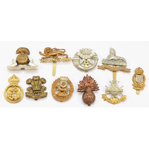 60 - Military Cap Badges (20), to include The Welsh, The Kings Own and The Lancashire Fusiliers.