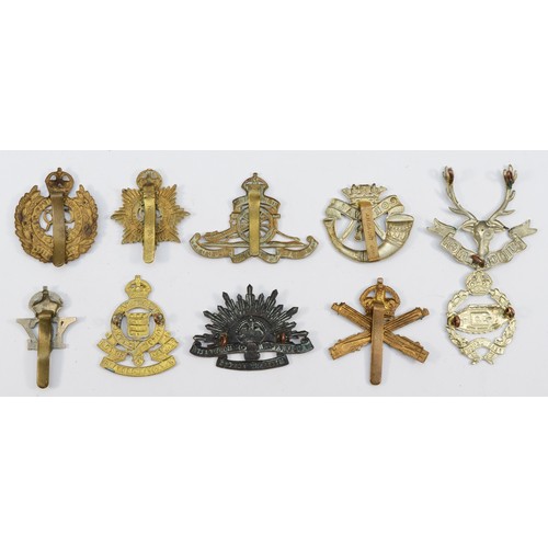 70 - Ten military cap badges, including Tank Reg and Machine Gun Corps