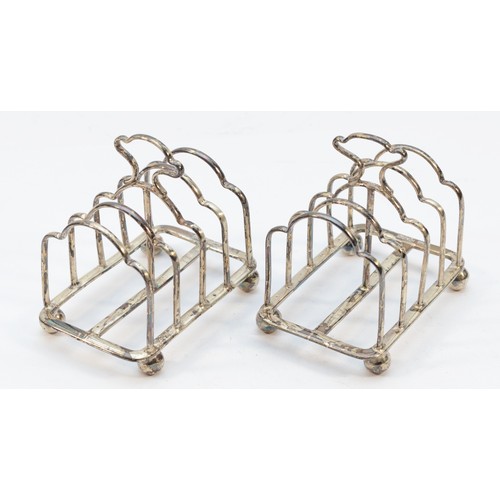 287 - A pair of silver four division toast racks, Sheffield 1924, raised on ball feet, 6.5cm, 82gm