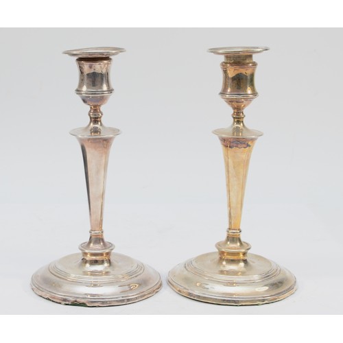 303 - A Victorian silver pair of table candlesticks, London 1897, of circular form, sconces 1909, 20cm, lo... 