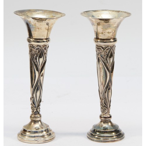 305 - An Art Nouveau silver pair of specimen vases, Sheffield 1913, with embossed decoration, 14.5cm, load... 