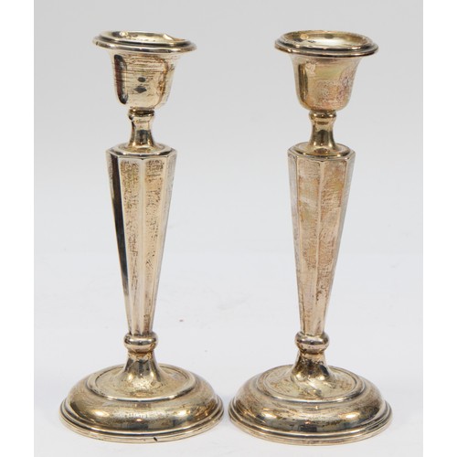 306 - A silver pair of candlesticks, Birmingham 1911, 17.5cm, loaded.