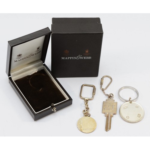 311 - A silver disc key ring, by Mappin & Webb, Sheffield 1997, case and two other silver key rings, 77gm