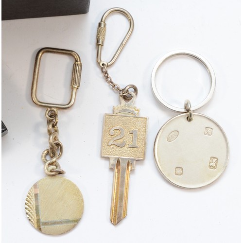 311 - A silver disc key ring, by Mappin & Webb, Sheffield 1997, case and two other silver key rings, 77gm