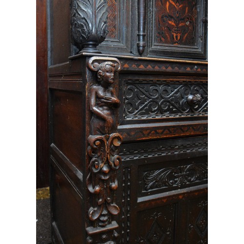 42 - A 17th Century and later carved oak court cupboard, top panel with G.L, 1649, flanked by grotesque m... 