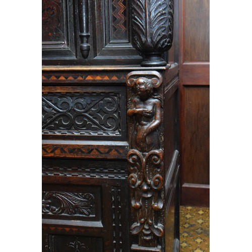 42 - A 17th Century and later carved oak court cupboard, top panel with G.L, 1649, flanked by grotesque m... 