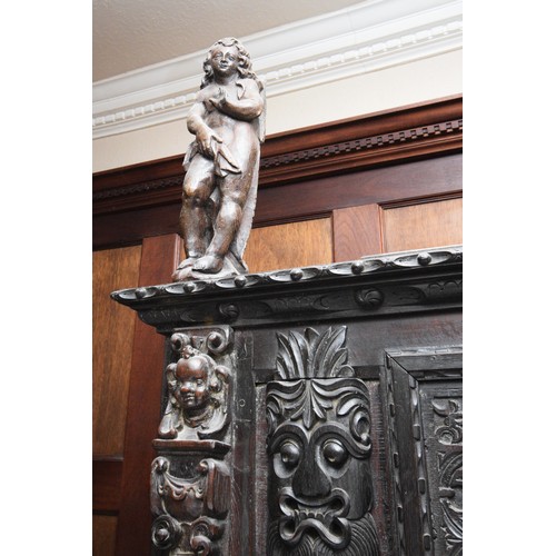 42 - A 17th Century and later carved oak court cupboard, top panel with G.L, 1649, flanked by grotesque m... 