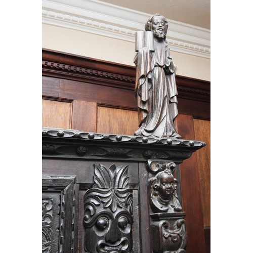 42 - A 17th Century and later carved oak court cupboard, top panel with G.L, 1649, flanked by grotesque m... 