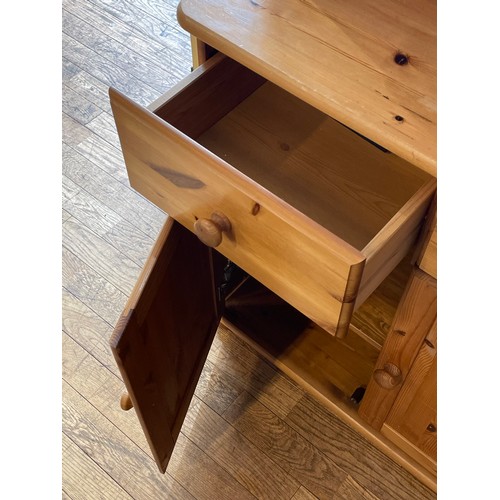 90 - A traditional pine dresser, the rack fitted with central shelf flanked by glazed cupboards, the base... 