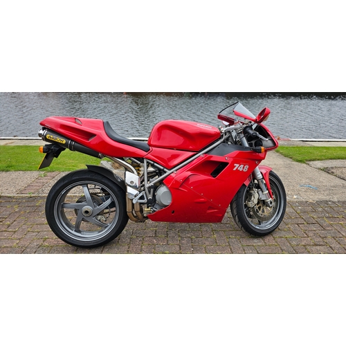 2001 Ducati 748. Registration number 009353. Engine number not found.
Sold with the V5C. 
The Ducati 748 is nearly identical to the iconic Ducati 916 but with a smaller engine (and narrower rear wheel). That means sublime handling on smooth surfaces, terrible comfort, high running costs and a feel-good experience most other motorcycles can’t touch. And few motorcycles match the simple, gorgeous curves of the Ducati 748.
The Ducati is standard apart from arrow exhaust cans and new battery.