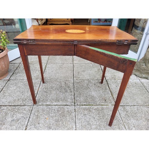 133 - A Victorian inlaid mahogany fold-over side table, having serpentine shaped top with astragal moulded... 