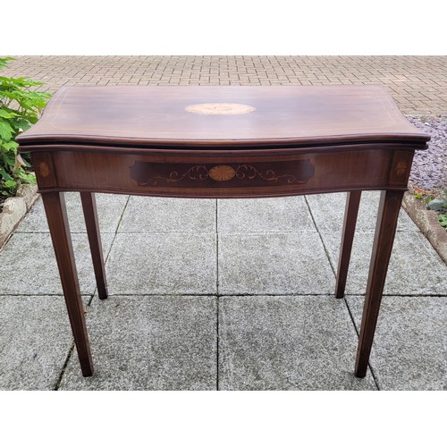 133 - A Victorian inlaid mahogany fold-over side table, having serpentine shaped top with astragal moulded... 