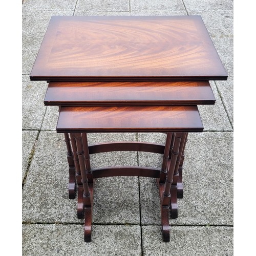 134 - An Edwardian nest of three mahogany and birdseye maple tables, rectangular, the mahogany tops broadl... 