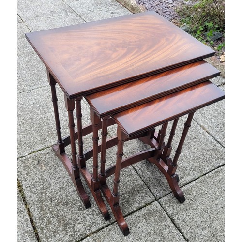 134 - An Edwardian nest of three mahogany and birdseye maple tables, rectangular, the mahogany tops broadl... 