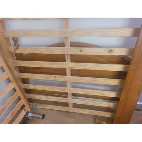 144 - A modern pine double bedstead, complete with ends, slatted base and fittings.