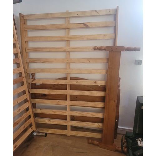 144 - A modern pine double bedstead, complete with ends, slatted base and fittings.