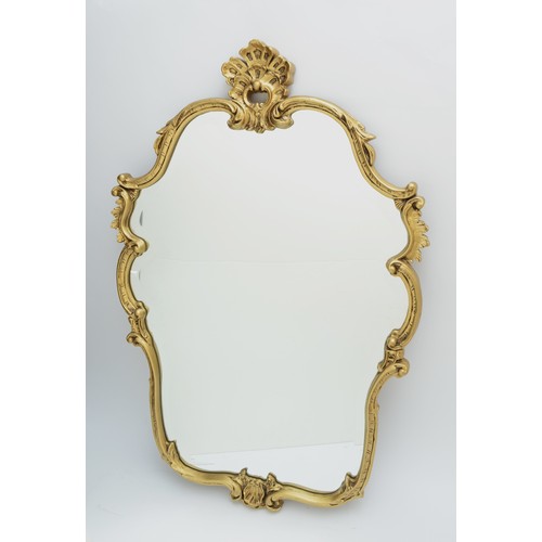 163 - A gilt framed Rococo style wall mirror, having bevel edge glass with scroll detail. 104 x 63cm