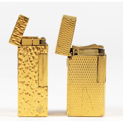 6 - Dunhill, a gold plated textured rollagas lighter, booklet and box and another by the same, serial nu... 