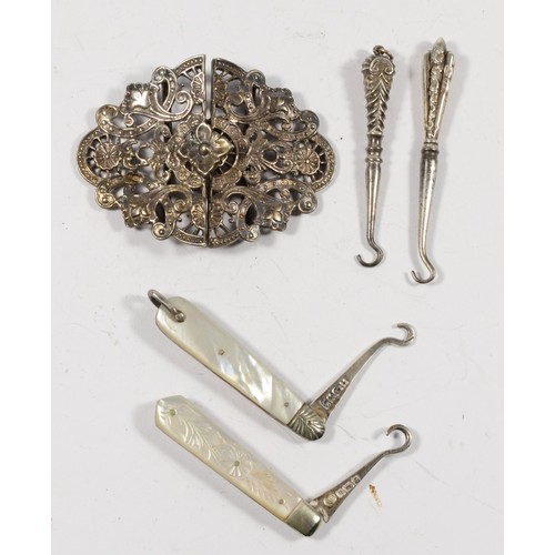 16 - Two Victorian silver and mother of pearl boot pullers, two silver and steel examples and a silver nu... 