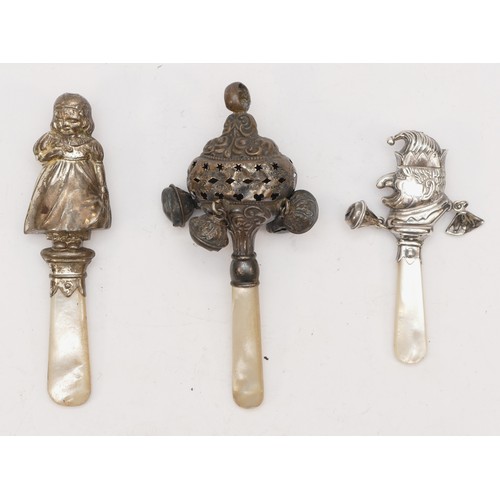 63 - A silver and mother of pearl rattle, Birmingham 1906, a Punch rattle, Chester 1959 and a 925 silver ... 