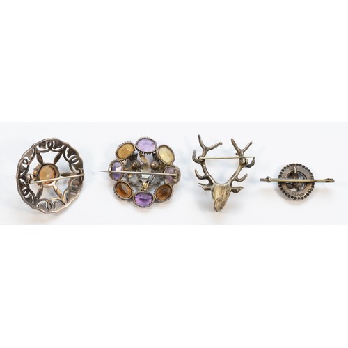 183 - A Scottish unmarked textured silver, amethyst and citrine target brooch, 38mm, an unmarked stag broo... 