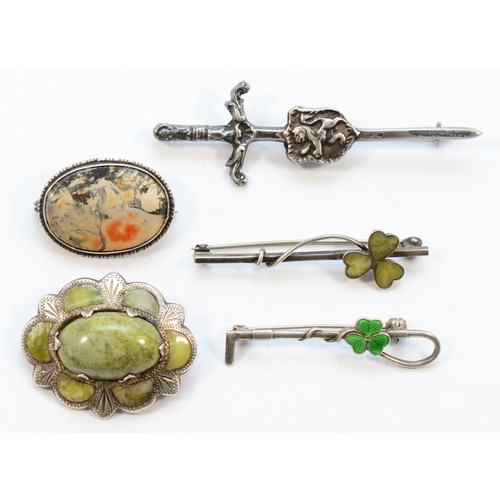 189 - Robert Allison, a Scottish silver broadsword and shield brooch and four other silver Celtic brooches