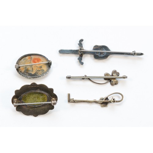 189 - Robert Allison, a Scottish silver broadsword and shield brooch and four other silver Celtic brooches