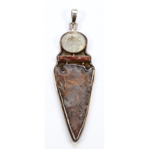 197 - An unmarked silver mounted flint arrowhead pendant with quartz above, 13cm overall