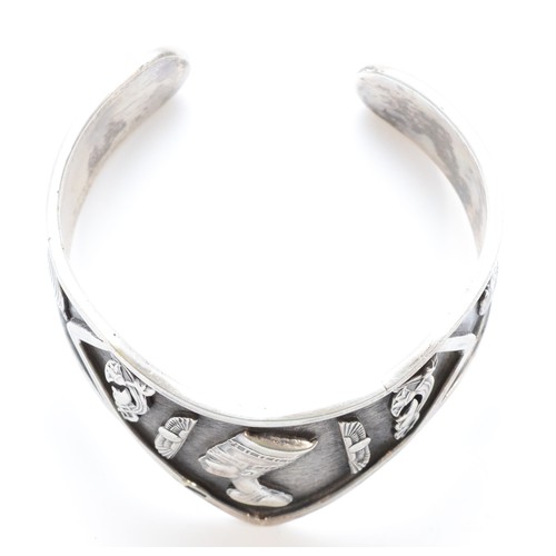 212 - An Egyptian silver bangle with various motifs, bearing control marks, 52gm