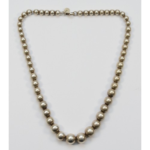 216 - Tiffany & Co. a silver bead necklace, 10 - 5mm diameter, length 40cm, 29gm