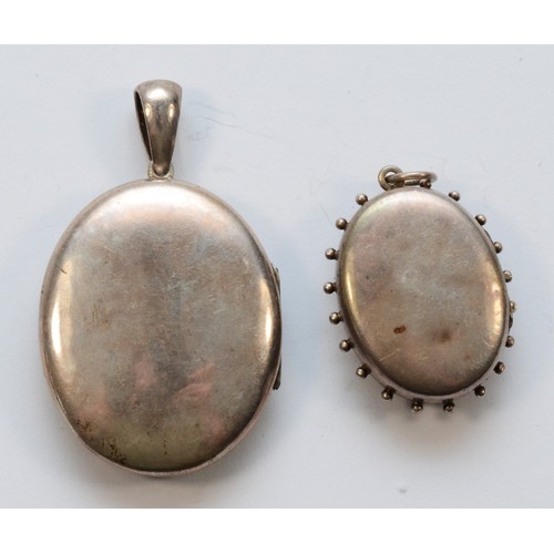 221 - Two unmarked Victorian silver lockets, the largest 53mm overall, 25gm