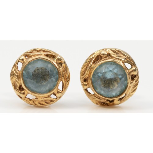 252 - A pair of 9ct gold aquamarine paste stud earrings with foliate patterned border, 2.3g