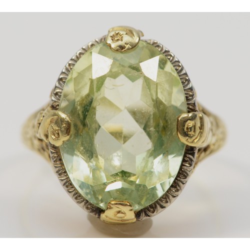 253 - A 14K gold Art Deco style green gemstone dress ring with a floral patterned mount, P, 5.7g