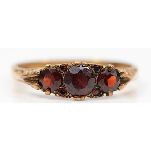 258 - A 9ct gold vintage garnet ring with a patterned gallery, Birmingham 1973, W, 3.2g