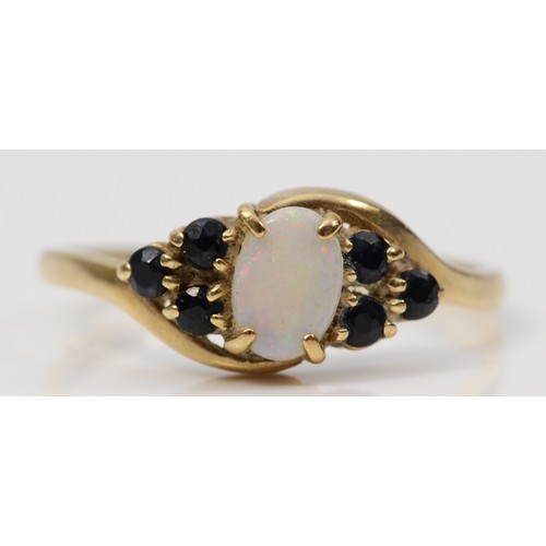 261 - A 9ct gold opal and sapphire dress ring, K, 1.3g