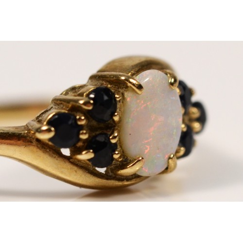 261 - A 9ct gold opal and sapphire dress ring, K, 1.3g