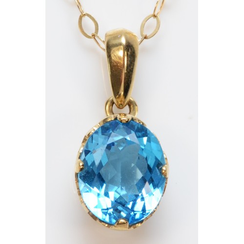 274 - A 9ct gold oval cut blue topaz pendant with necklace, 12mm x 10mm topaz, 4.1g