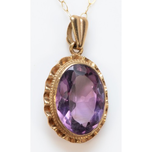 292 - A 9ct gold oval cut amethyst pendant, with necklace, 13mm x 9mm amethyst, 2.6g