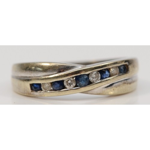 306 - A 9ct white gold sapphire and diamond crossover ring, L 1/2, 2.8g