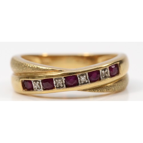 307 - A 9ct gold ruby and diamond crossover ring, N, 3.3g