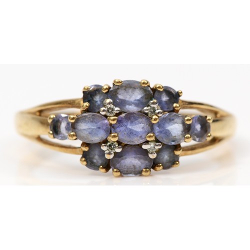 311 - A 9ct gold oval cut tanzanite and diamond dress ring, R, 2.5g