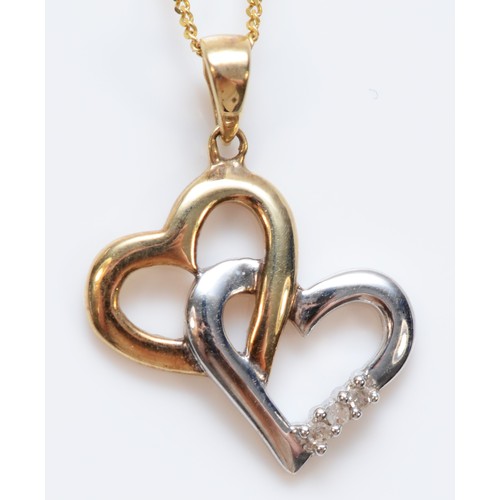 333 - A 9ct gold diamond double heart shaped pendant, with chain, 14mm across pendant, 1.7g