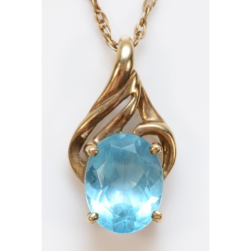 341 - A 9ct gold vintage oval cut blue topaz pendant with chain, total pendant length is 17mm, 2.1g