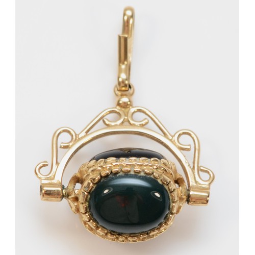 353 - A 9ct gold vintage carnelian, onyx and bloodstone spinning fob, 3.2g