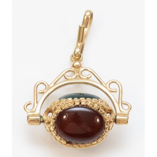 353 - A 9ct gold vintage carnelian, onyx and bloodstone spinning fob, 3.2g