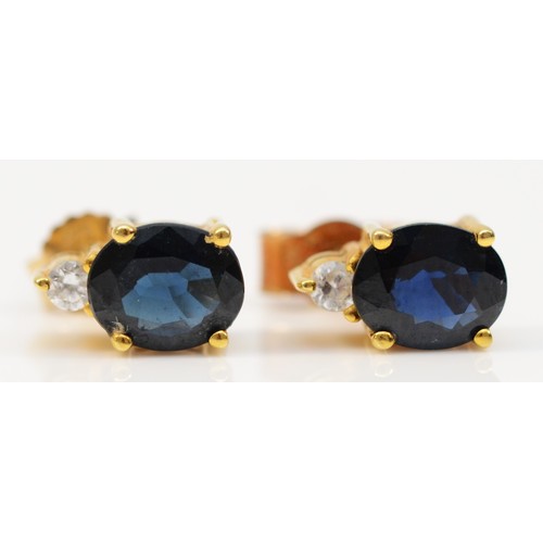 361 - A pair of 14k gold sapphire and cubic zirconia stud earrings with 9ct gold scroll backs, 1.8g