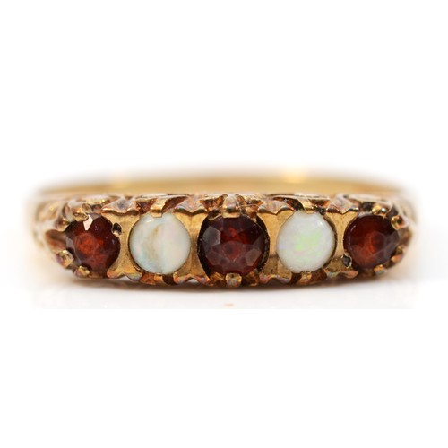 370 - A 9ct gold vintage garnet and opal ring with a patterned gallery, Q 1/2, 2g